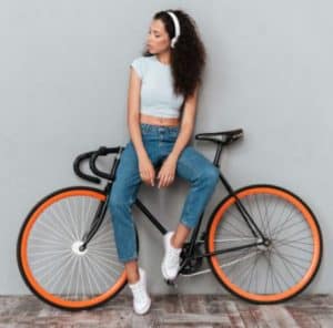 can you add gears to a single speed bike A young woman sitting on a bicycle's top tube