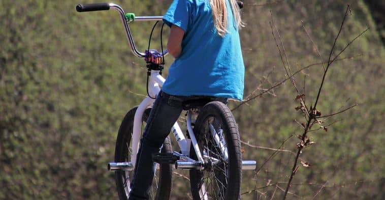 can you put pegs on a mountain bike? A cyclist sitting on a bike with pegs